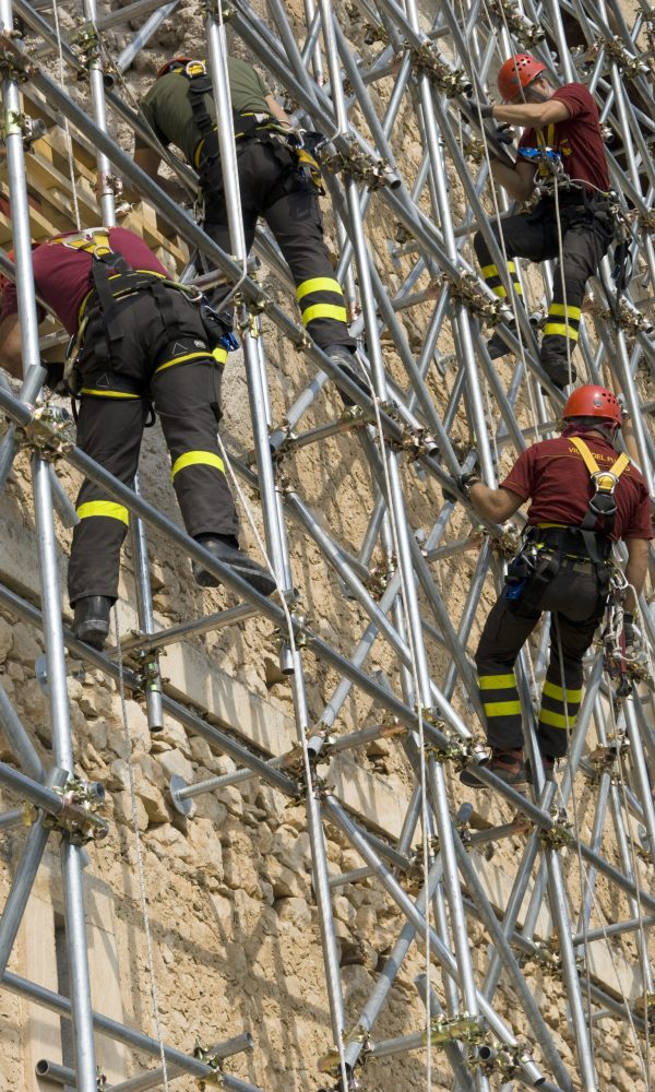 construction-workers-climbing-scaffolding-against-2026-03-25-23-29-40-utc