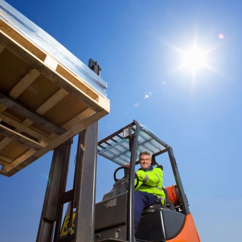 forklift-operator-lifts-pallet-under-blue-sky-2026-01-11-08-40-16-utc