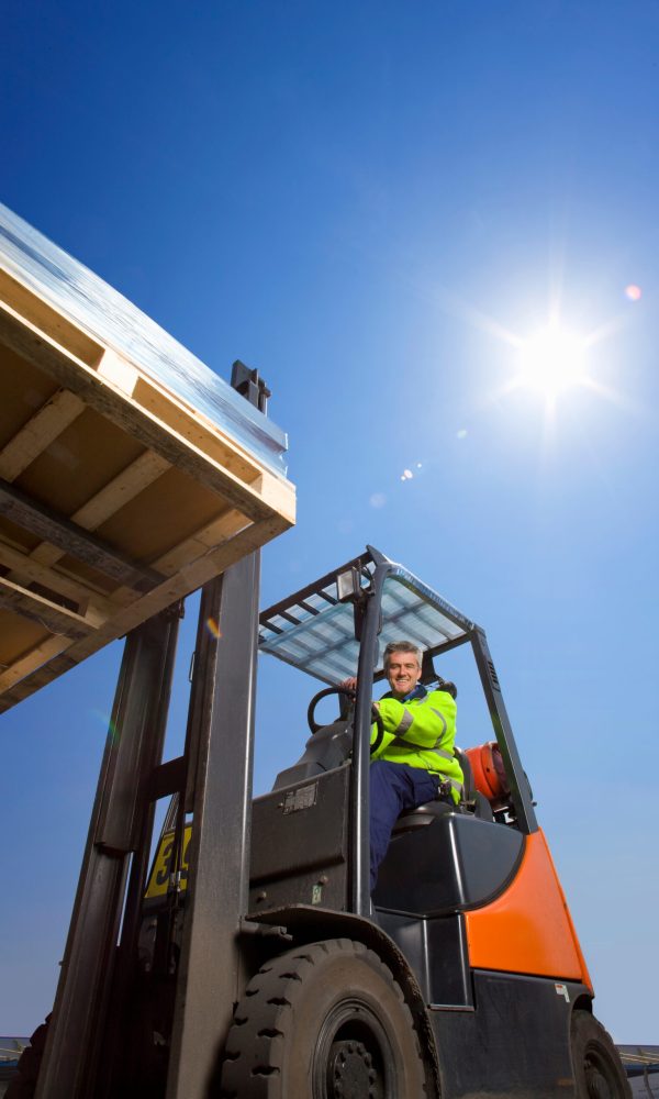 forklift-operator-lifts-pallet-under-blue-sky-2026-01-11-08-40-16-utc