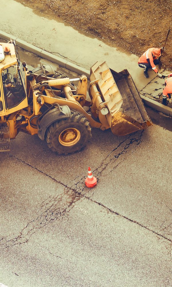 road-workers-repairing-pavement-with-heavy-equipme-2026-01-11-09-01-58-utc