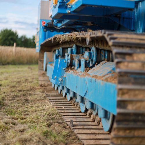 A vertical shot of large industrial machinery on a meadow