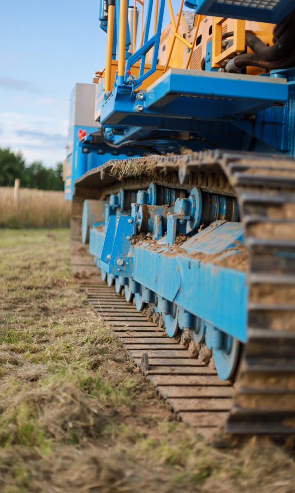 A vertical shot of large industrial machinery on a meadow